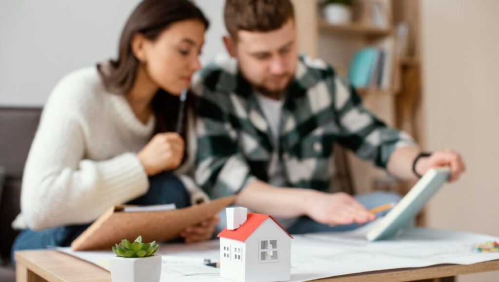 Dos ejecutivos se reúnen en un entorno elegante y privado para analizar detalladamente documentos relevantes, evaluando oportunidades de inversión inmobiliaria. Sobre la mesa destacan una maqueta arquitectónica y elementos decorativos discretos, subrayando el enfoque en propiedades residenciales de alto valor y proyectos con potencial de plusvalía superior. Esta escena refleja el rigor profesional y la visión estratégica que caracterizan a quienes participan en el segmento premium del mercado inmobiliario.