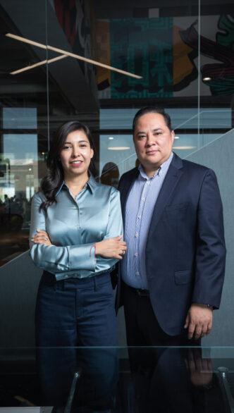 Dos profesionales, una mujer y un hombre, se posan juntos en un entorno interior elegante, ataviados con impecable indumentaria ejecutiva. Con una clara demostración de inteligencia estratégica y visión analítica, se preparan para llevar a cabo un análisis integral del mercado industrial premium en México. Su actitud decidida y enfoque profesional refleja el compromiso de brindar soluciones de alto valor para inversores y compradores que buscan oportunidades exclusivas dentro del sector inmobiliario más exigente.