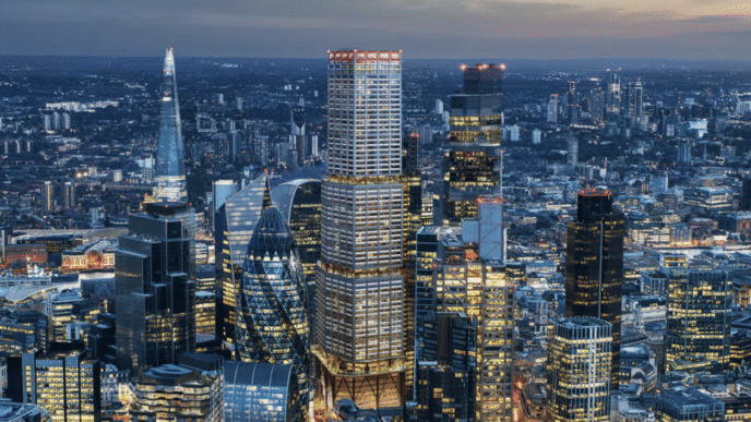 Vista aérea nocturna de Londres mostrando el horizonte con rascacielos iluminados, incluyendo el 1 Undershaft, el nuevo rascacielos más alto.