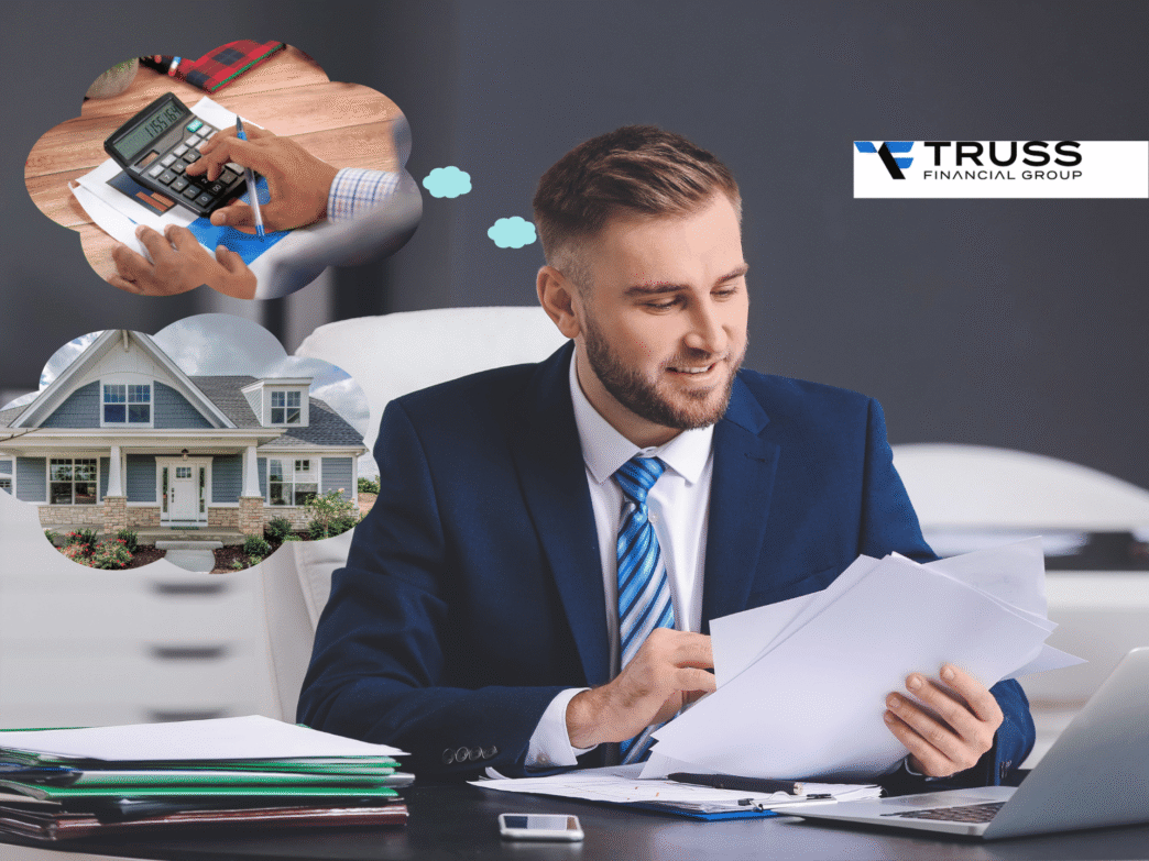 Un hombre de negocios revisa documentos en su escritorio, pensando en finanzas y una casa. Logo de Truss Financial Group visible.
