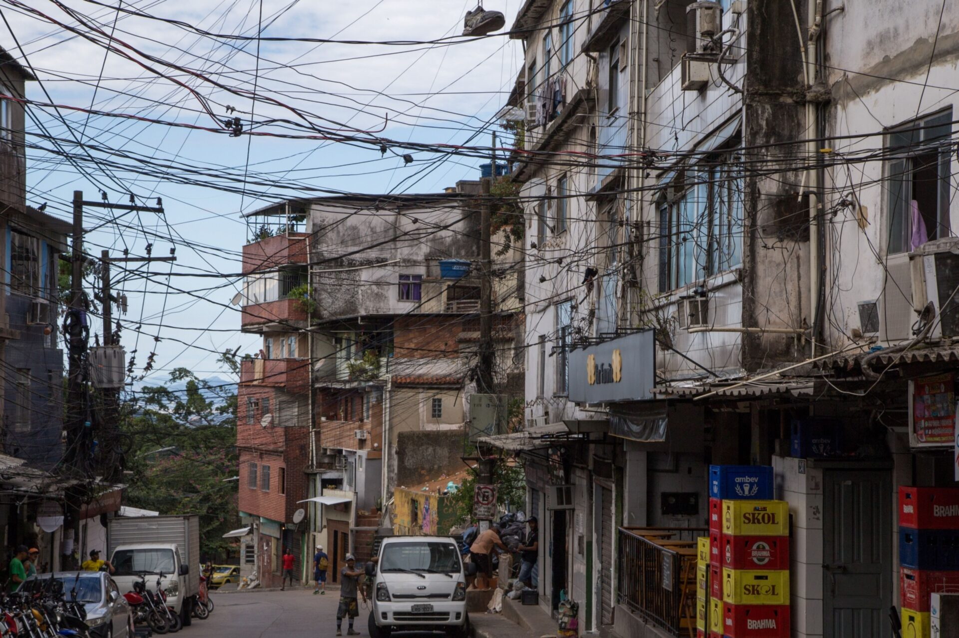 Ciudad de LATAM con cableado aéreo denso. Viviendas precarias en la calle. Estrategia de autoproducción de vivienda en Inmobiliare Summits.