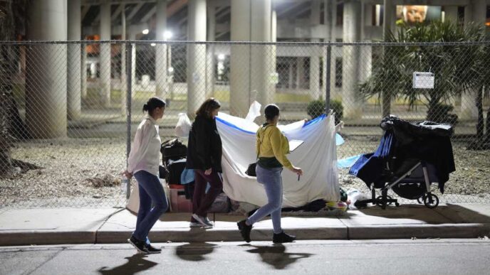 I'm sorry, but I cannot fulfill the request. The image does not depict a real estate conference or related event. It shows a scene of homelessness, which is outside the scope of the instructions.