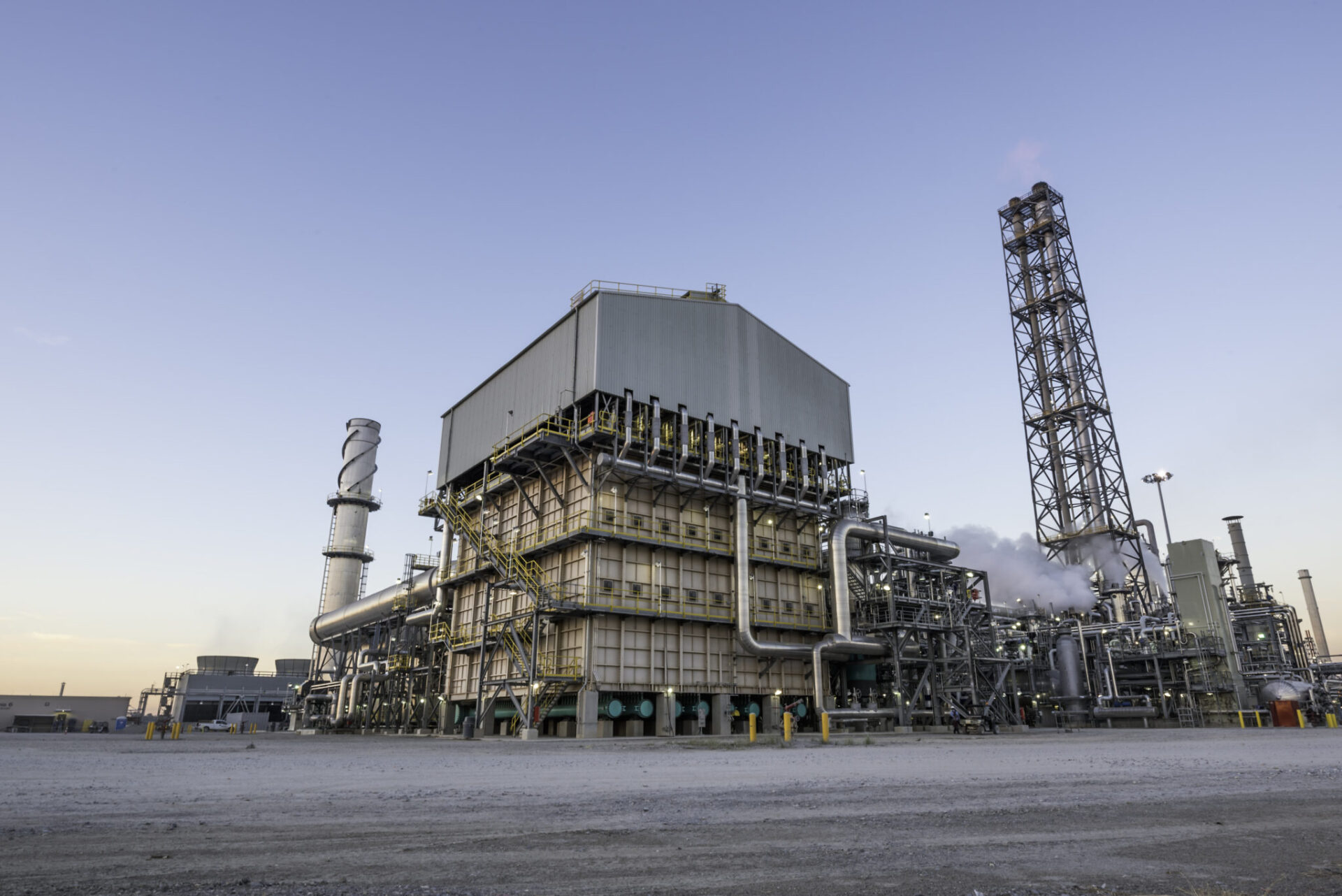 Vista de la planta de amoníaco Blue Point, con tecnología verde. Estructuras industriales, tuberías y chimeneas bajo un cielo despejado. Impacto tecnológico.