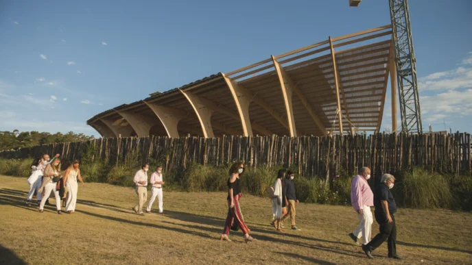 Visitantes recorren el MACA de Uruguay, museo orgánico en construcción. Arquitectura de madera fusionada con el entorno natural. Obra en progreso.