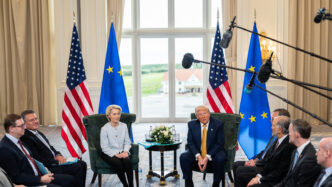 venue/architecture
Donald Trump y Ursula von der Leyen en una reunión. Banderas de EE. UU. y la UE de fondo. Reunión en un venue con luz natural.