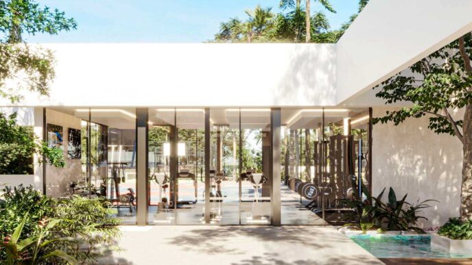 Gimnasio moderno en Gran Telchac, la joya de La Nueva Riviera de México. Equipado con máquinas y rodeado de exuberante vegetación tropical.