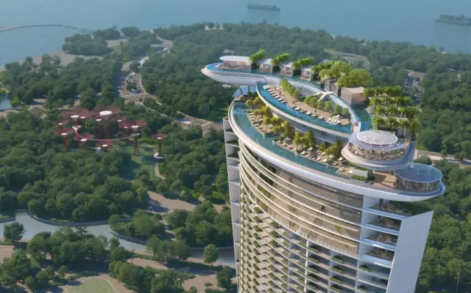 Vista aérea del Hotel Marina Bay Sands, Singapur, mostrando su diseño único con piscina en la azotea. Cuarta torre abrirá en 2029. Lujo y modernidad.