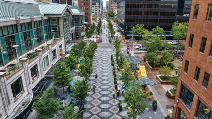 Perspectiva elevada de calle urbana con infraestructura verde: árboles, zonas peatonales y edificios. Transformando el futuro urbano con naturaleza.