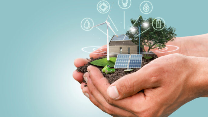 Mano sosteniendo tierra con miniatura de casa, panel solar y molino. Iconos de energía renovable. Innovación en biocombustibles y Real Estate.