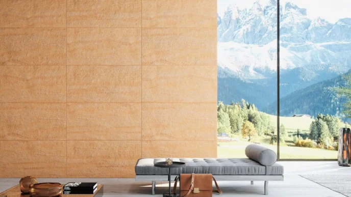 Interior moderno con pared de piedra natural, promoviendo innovación y sostenibilidad. Diseño con luz natural y vistas a la montaña. Uso piedra.