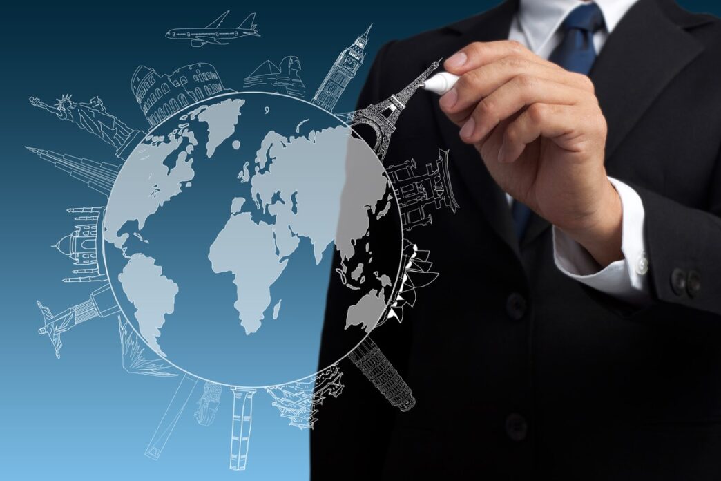 Ilustración conceptual de expansión global en Inmobiliare Summits. Un hombre dibuja monumentos mundiales en un globo. Inversión LATAM en México.