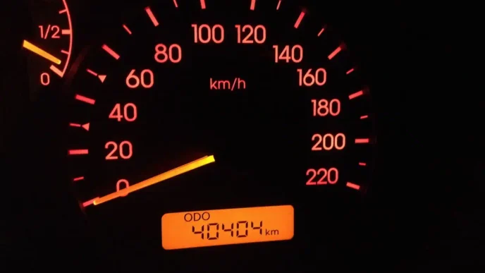 This image doesn't appear to be related to the keywords provided. Here's an alt text based on the image content:

Velocímetro de coche marcando 20 km/h y odómetro con 40404 km. Panel iluminado con luz roja.