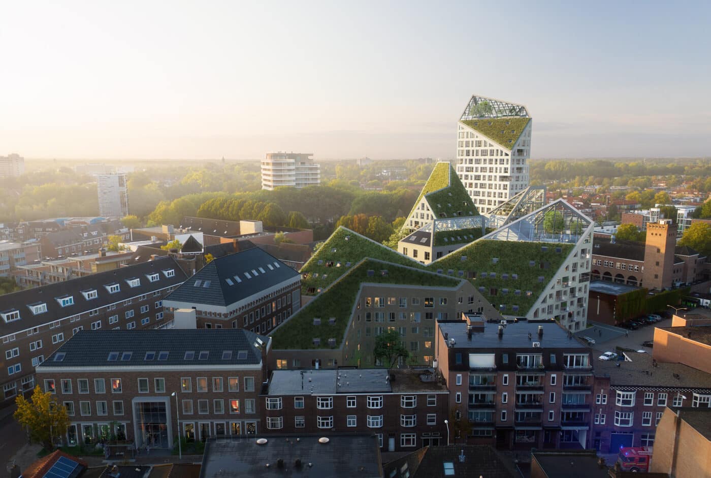 Vista aérea de Nieuw Bergen, proyecto de MVRDV en Países Bajos. Arquitectura moderna con techos verdes integrados en el paisaje urbano. Diseño innovador.