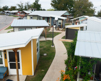 Vista aérea de viviendas para jóvenes: casas pequeñas, coloridas y con diseño accesible. Espacios dignos y pensados para la juventud.