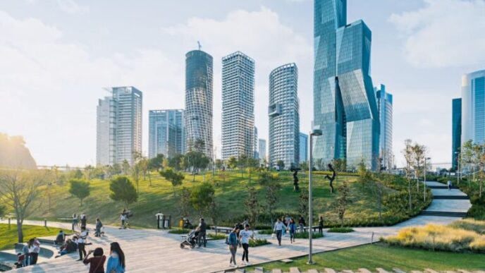 Urban park with modern skyscrapers in the background.