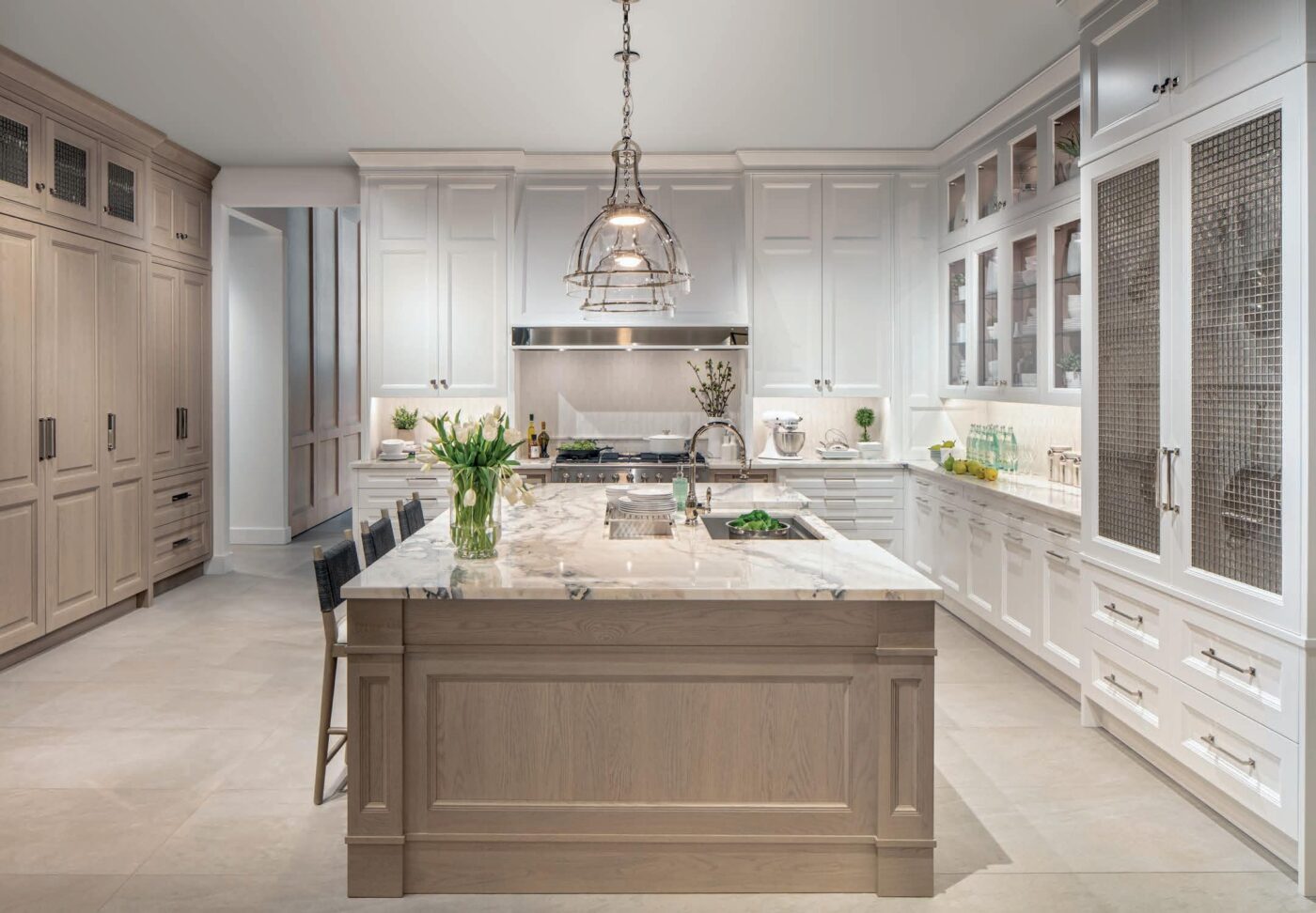 Cocina de lujo Mulinelli con mobiliario de diseño. Isla central de mármol, gabinetes blancos y detalles de alta gama. Entrega inmediata México.