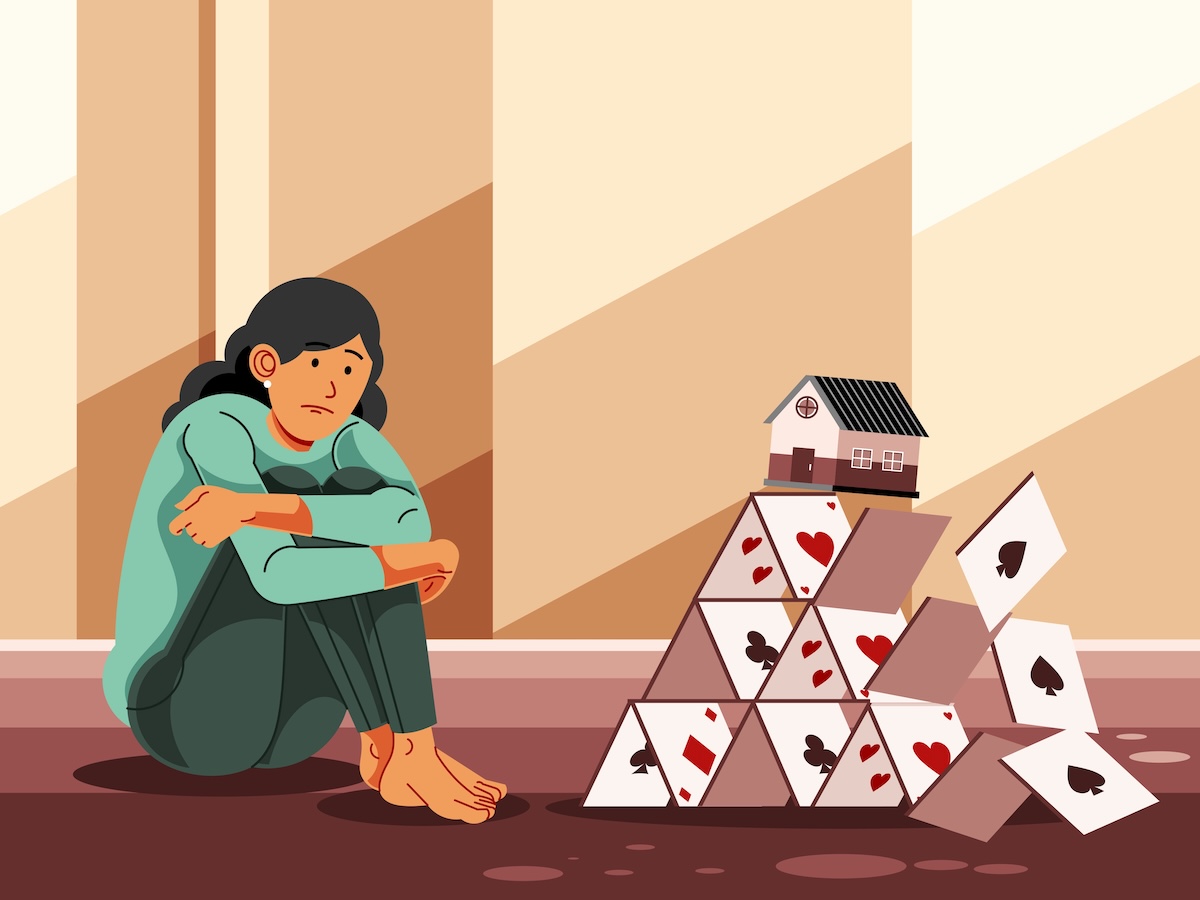 Persona sentada junto a una casa de cartas colapsando, texto el mercado inmobiliario residencial de Estados Unidos 2026.